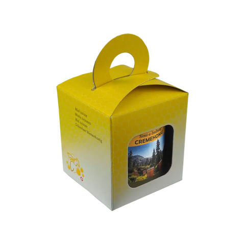 Geschenkbox mit einem Bündner Cremehonig 250g in gelber Verpackung dem Schriftzug Schweizer Bienenhonig, mit Tragegriff und Sichtfenster