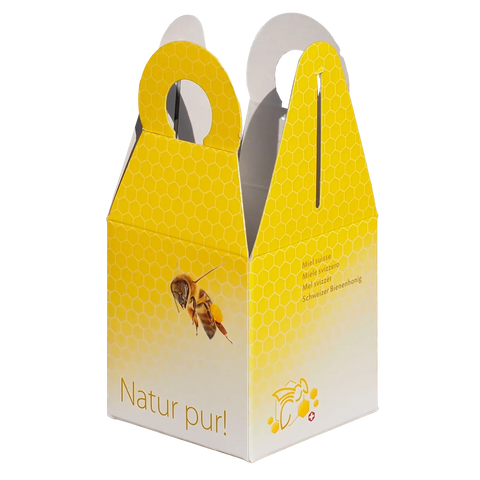 Karton-Geschenkbox in gelb-weisse mit einer Biene darauf und dem Schriftzug Natur pur! Mit Tragegriff und Wabendesign für ein Honigglas 500g