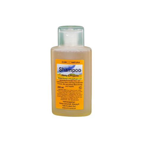 eine durchsichtige Flasche mit einem Etikett Shampoo Honig und Propolis. Mildes Shampoo mit natürlichem Bienenhonig und Propolis in 200 ml Flasche, pflegend für Haar und Kopfhaut, verleiht Glanz und Frische bei täglicher Anwendung.